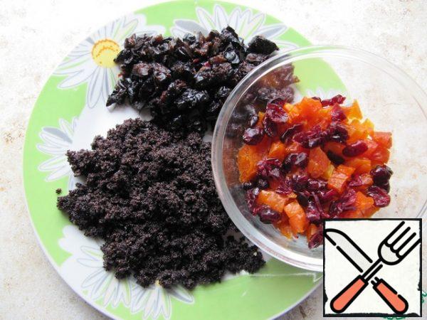 To prepare the poppy filling, wash the seeds, pour water, boil, and drain the water. Re-fill the poppy seeds with water, cook for 20 minutes until the grains soften, and drain with a sieve. Mac with sugar (to taste) grind with a blender, put in a saucepan, add honey (if desired), dry until the liquid evaporates on low heat, the filling should be crumbly, without excess moisture. Wash the prunes, dry them, and cut them into cubes. Combine 100 g of ready-made Maca and 100 g of sliced prunes, mix. To prepare the filling from dried apricots, pre-wash the fruit, dry it, cut into a small cube. Dried cherries also wash, dry, combine the chopped dried apricots and cherries, mix.