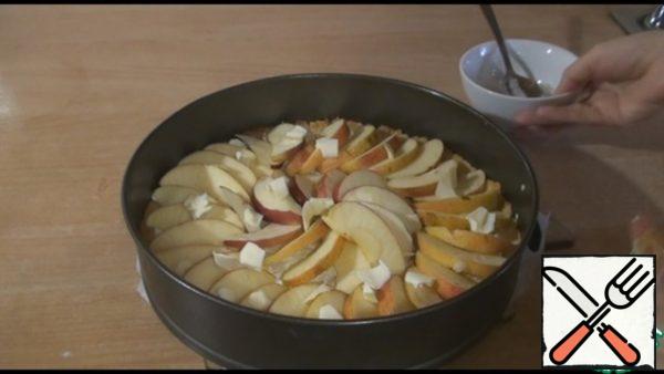 Put small pieces of butter on top of the apples.