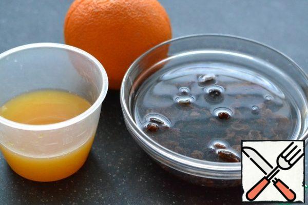 Prepare orange juice. Pour hot water over the raisins.
