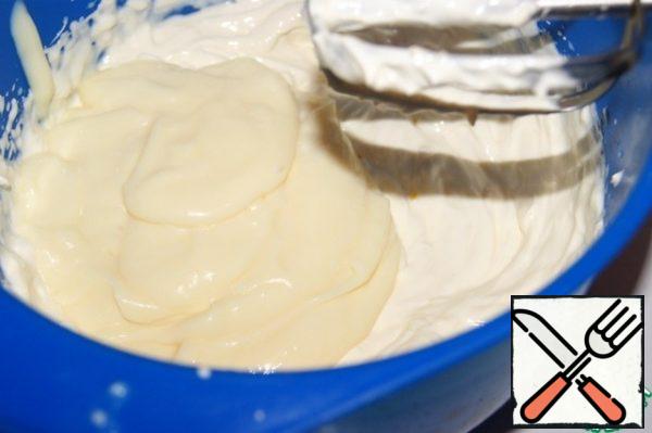 Whisk cream cheese with yogurt and zest.
Add the thickened condensed milk and whisk again.
