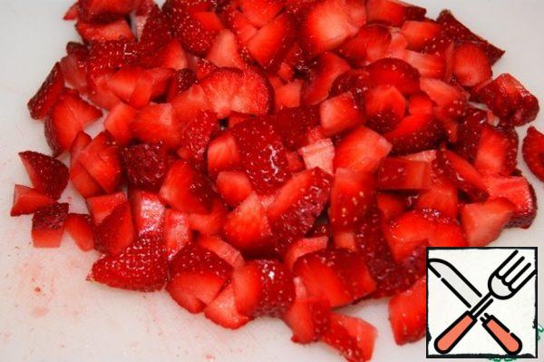 Add the chopped strawberries to the mousse and mix gently.