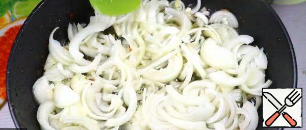 Cut the onion into half rings. In a frying pan, fry the onion (in the same oil as the thighs).