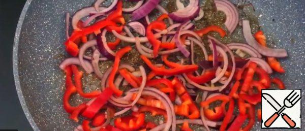 Fry the peppers and onions in the same pan where the bacon was cooked.
