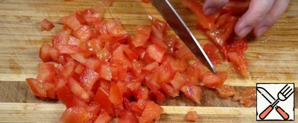Remove the seeds from the tomato and cut into cubes.
