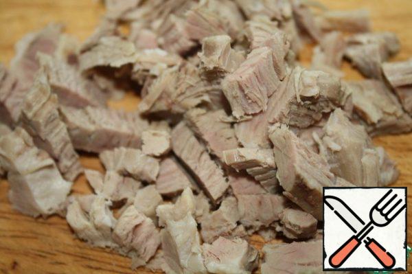 Cut the boiled pork into cubes.