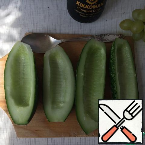 Cut the cucumbers lengthwise into 2 halves. Remove the seeds with a small spoon.