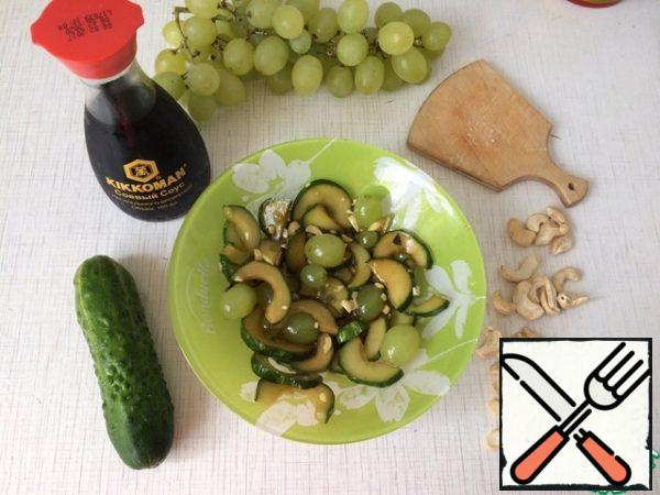 Put the cucumbers in the salad and mix. Put the salad in the refrigerator for 1 hour. Serve cold, sprinkled with chopped nuts on top.