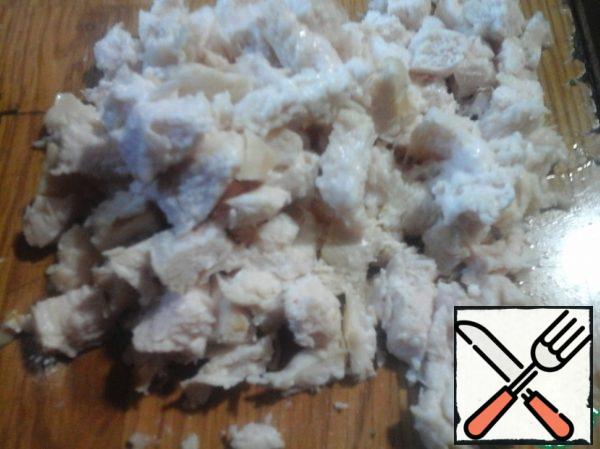 Cut the boiled chicken breast into cubes.