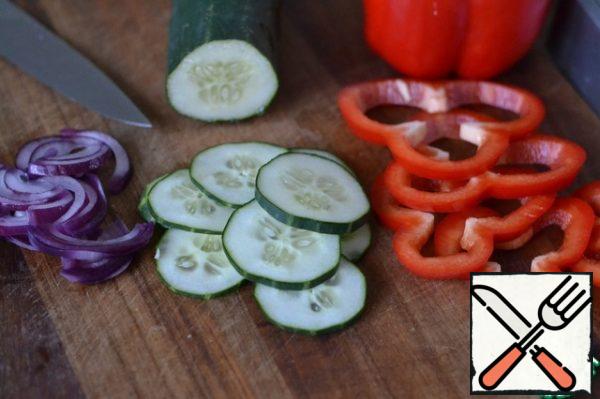 Pepper, cucumber and red onion cut into rings.
