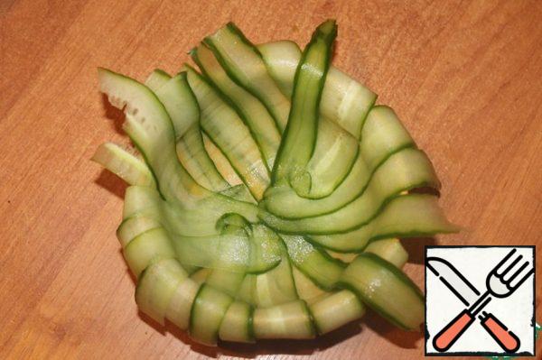 Cut off the tails of cucumbers and use a vegetable peeler to remove the long plates. Put them in a bowl.