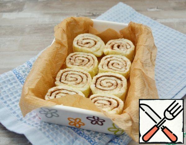 Place the rolls in a baking dish lined with parchment.
