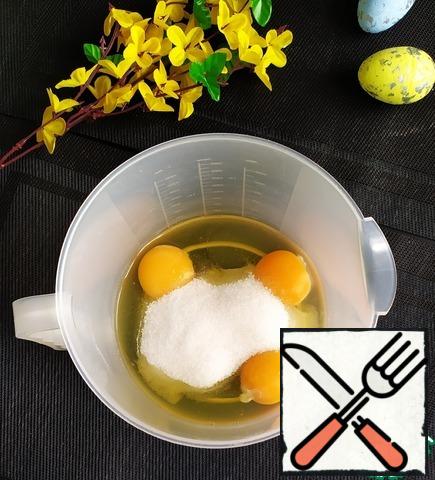 In a bowl, beat the eggs with sugar to a stiff froth.