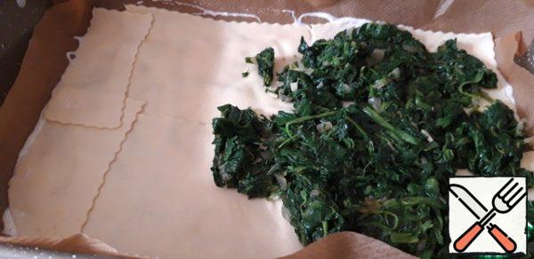 Spread the dough sheets over the entire form, with half a portion of spinach on top.