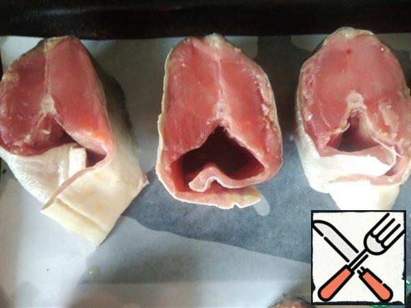 Wash the fish, clean it, and cut it into steaks.