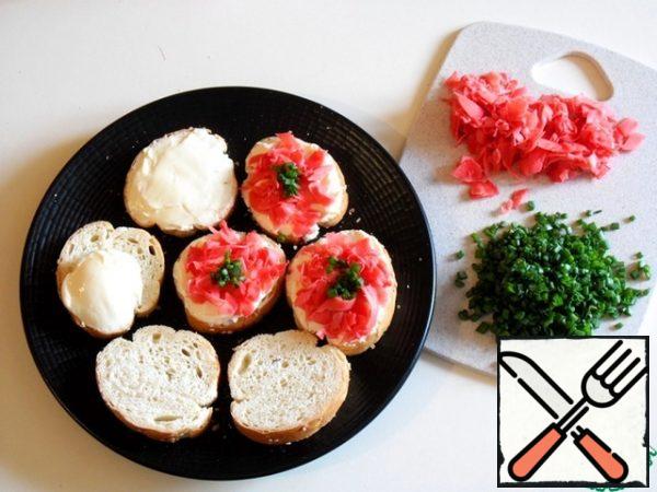 Spread the cheese on slices of bread, spread evenly, put strips of ginger on the cheese and sprinkle with herbs.