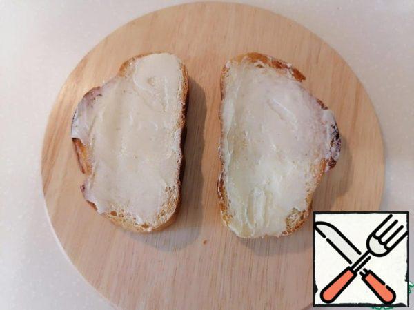 While the bread is still warm, grease with butter.