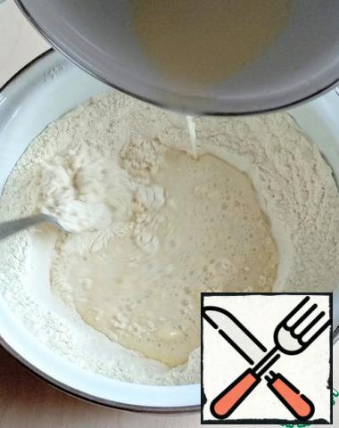 Sift the flour into the container and slowly add the liquid ingredients to the center, stirring with a fork or whisk.