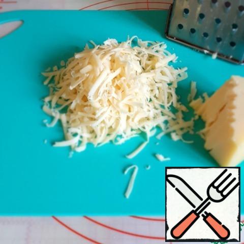 Grate the cheese on a coarse grater.