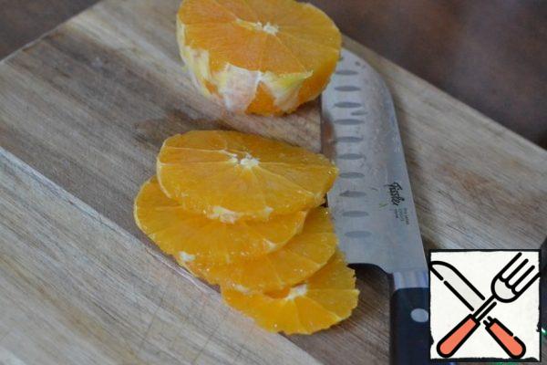 Peel the orange and cut it into rings.