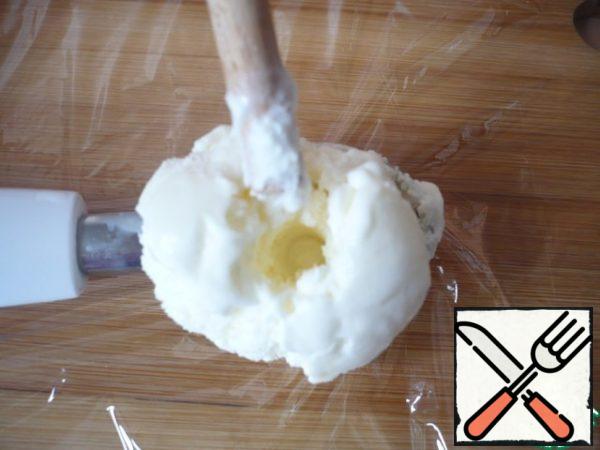 Stick a wooden stick through the hole in the center of the ice cream ball.