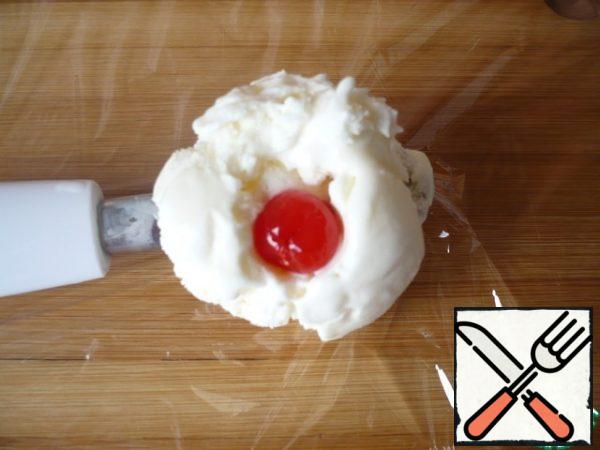 Put a cocktail cherry (without a stone) in the hole.