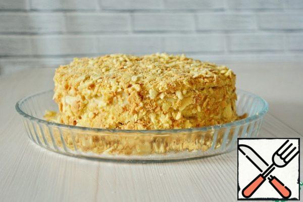 When all the cakes are layered, smear the top and sides of the cake with cream and sprinkle with crumbs.