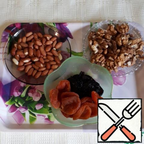 The main ingredients that will be required for the candy. The nuts must first be lightly fried, and the husks removed from the peanuts. Dried apricots and prunes scald with boiling water and dry with a towel.