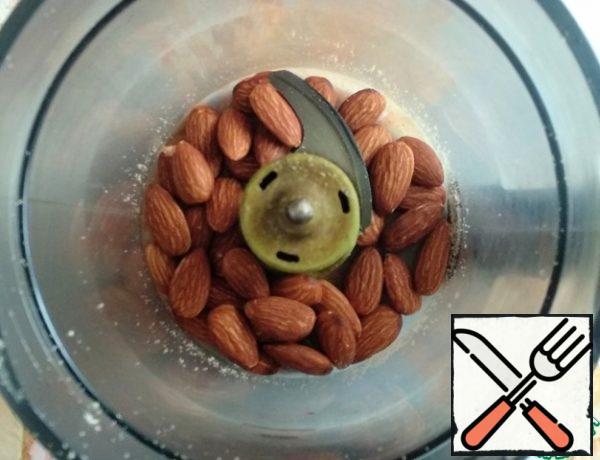 Place the almonds in a blender.