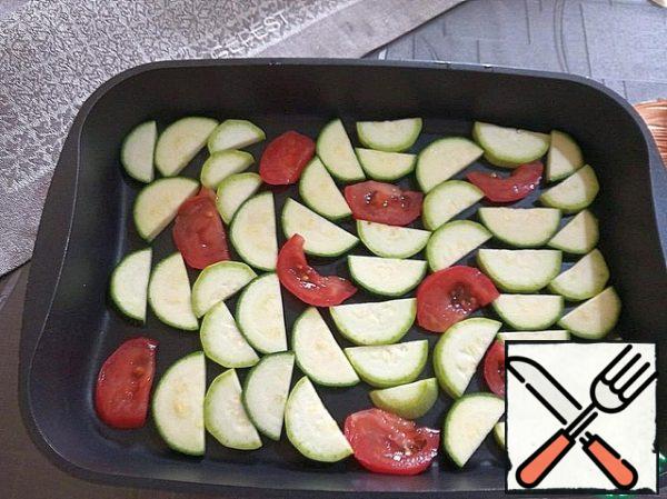 Part of the vegetables are spread on a baking sheet.