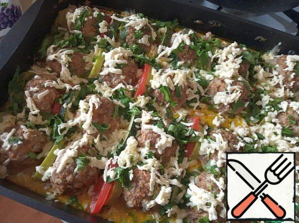 Remove the foil from the baking sheet and sprinkle our meat balls with herbs first, and grated cheese on top. And again send in the oven, but for 10 minutes.
