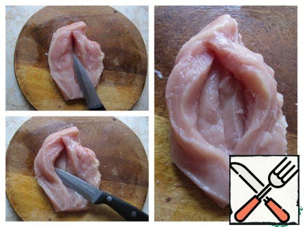 Wash the chicken fillet, separate the small fillet, and dry with a paper towel. Cut along, but not to the end, then make a cut to the left-inside and to the right-inside.