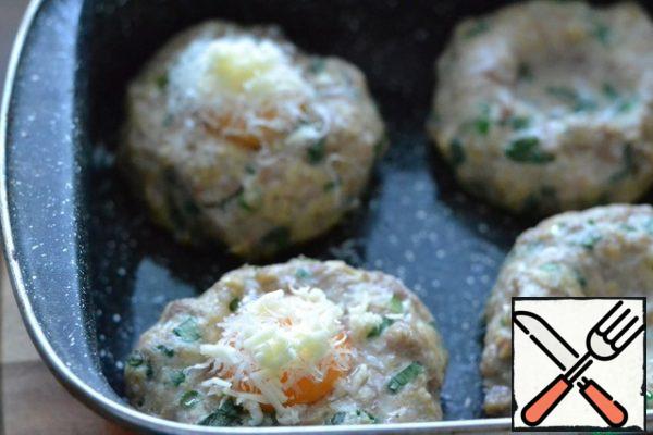 Put grated cheese on top of the yolk.
Return the pan with the cutlets back to the oven and bake for another 20 minutes.

