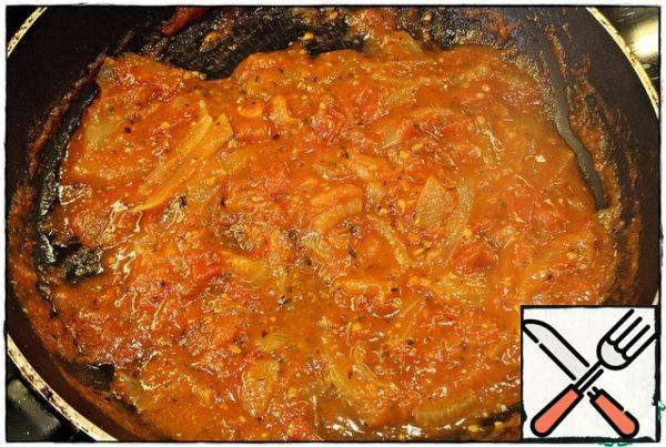 Then add a tablespoon of tomato paste, mix well, and simmer for another minute. Then add our herbs, salt, pepper, dry garlic and mix, simmer for a couple of seconds, add water and mix again. Simmer for two to three minutes.
