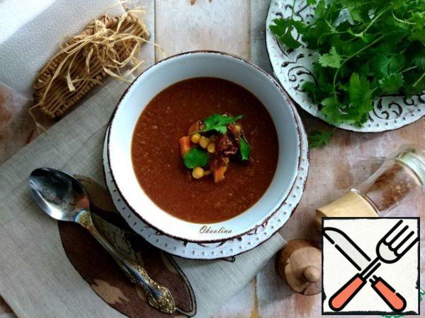 Pour on plates. In the center, spread the vegetables with chickpeas and decorate with coriander leaves or other herbs. Useful aromatic soup-puree with a rich tomato and spicy taste!