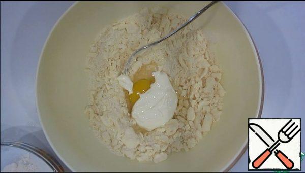 Add the egg and sour cream.