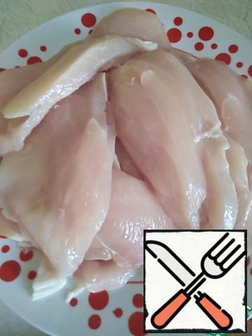Wash the chicken breast, cut it lengthwise into plastics, and beat it off with a hammer