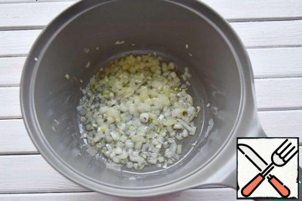 In a pan, pour vegetable oil and fry finely chopped onions.