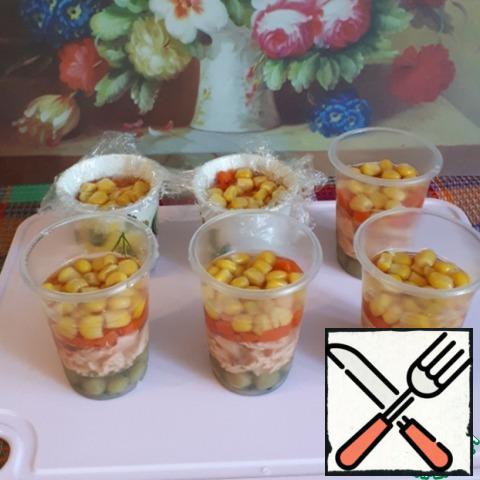 After the fish layer has frozen, put the corn and carrots, cut into small cubes, pour a small amount of broth, put in the refrigerator.