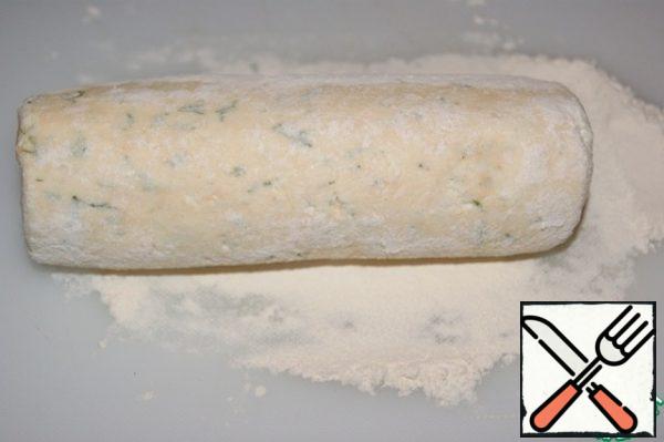 Roll into a sausage and lightly roll in flour. Cut into 2.5 cm thick washers. Roll the washers on both sides, when molding it round the curd.