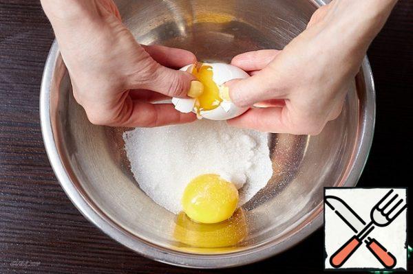 Pour the sugar into a bowl. Put the yolk there.