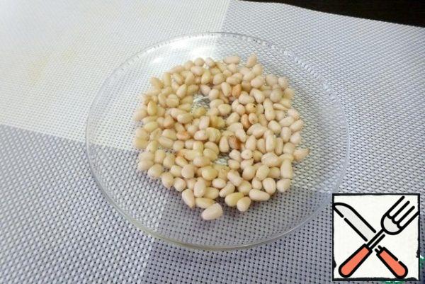 Dry pine nuts in the microwave or in a dry pan until light yellow. Make sure they don't burn!