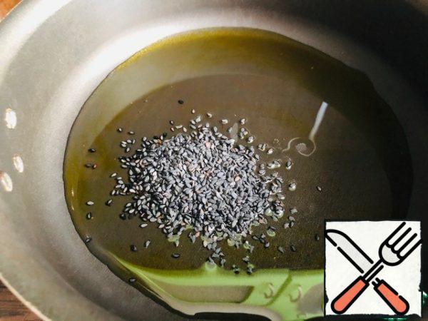 Add vegetable oil and sesame seeds to the pan. Fry.