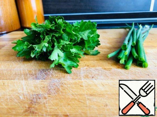 A bunch of coriander and green onions finely cut.