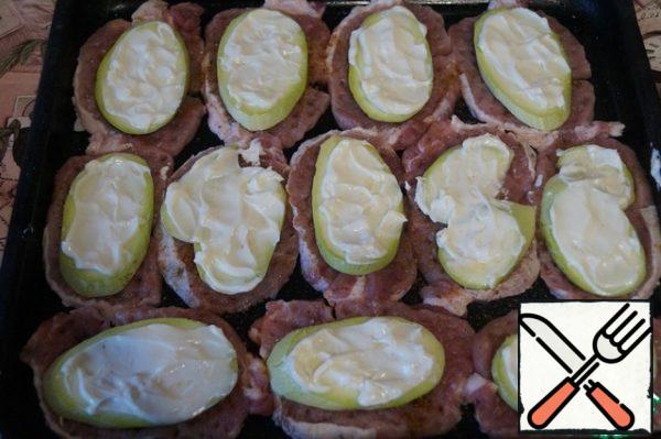Put zucchini on top of each piece of meat and grease it with soft melted cheese.