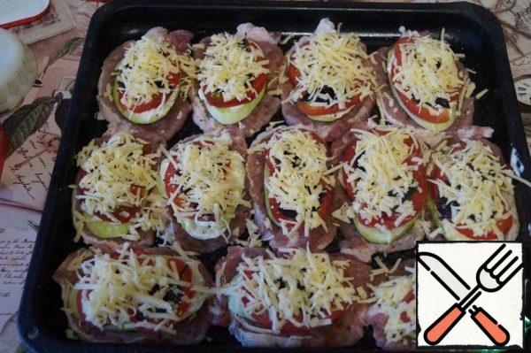 Grate the hard cheese and place it on top of the tomatoes.