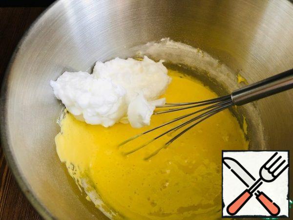 Gradually add the whipped whites to the mixture of yolks and flour, kneading the mass with a spatula or whisk from the bottom up. 