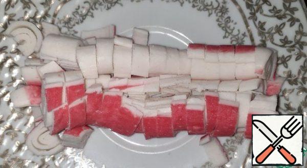 Cut the crab sticks (or shrimp).