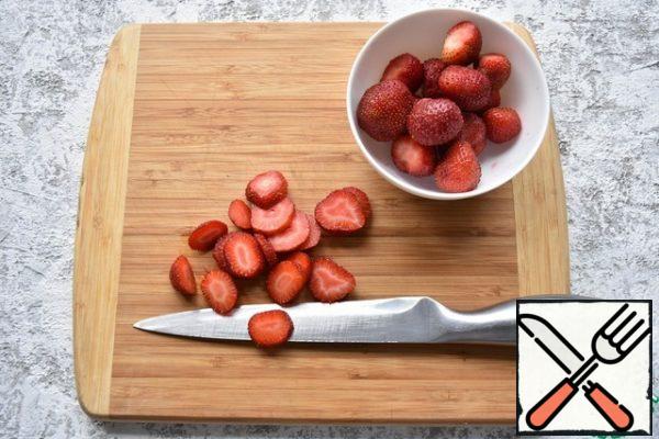 Cut the strawberries into circles or quarters. I leave some of it, and some of it will be used to make the syrup.