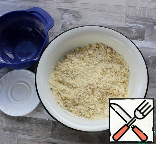 Punch a blender into the crumbs. ( Or alternatively, grate the cold butter, mix it with the other ingredients, and quickly RUB it into a crumble with your fingers.)