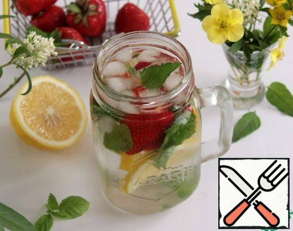 Fill a jug or jar with ice, sliced lemon, strawberries, and Basil. Filled with cold filtered water.